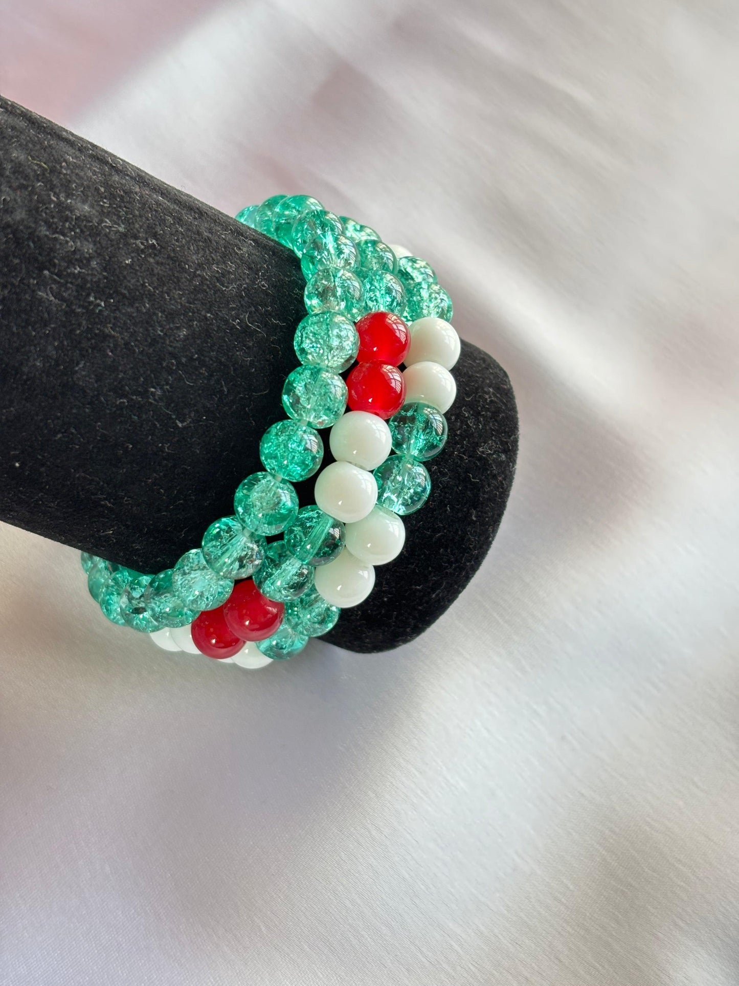 Festive holiday bracelet set featuring green, red, and white beads for seasonal celebrations.