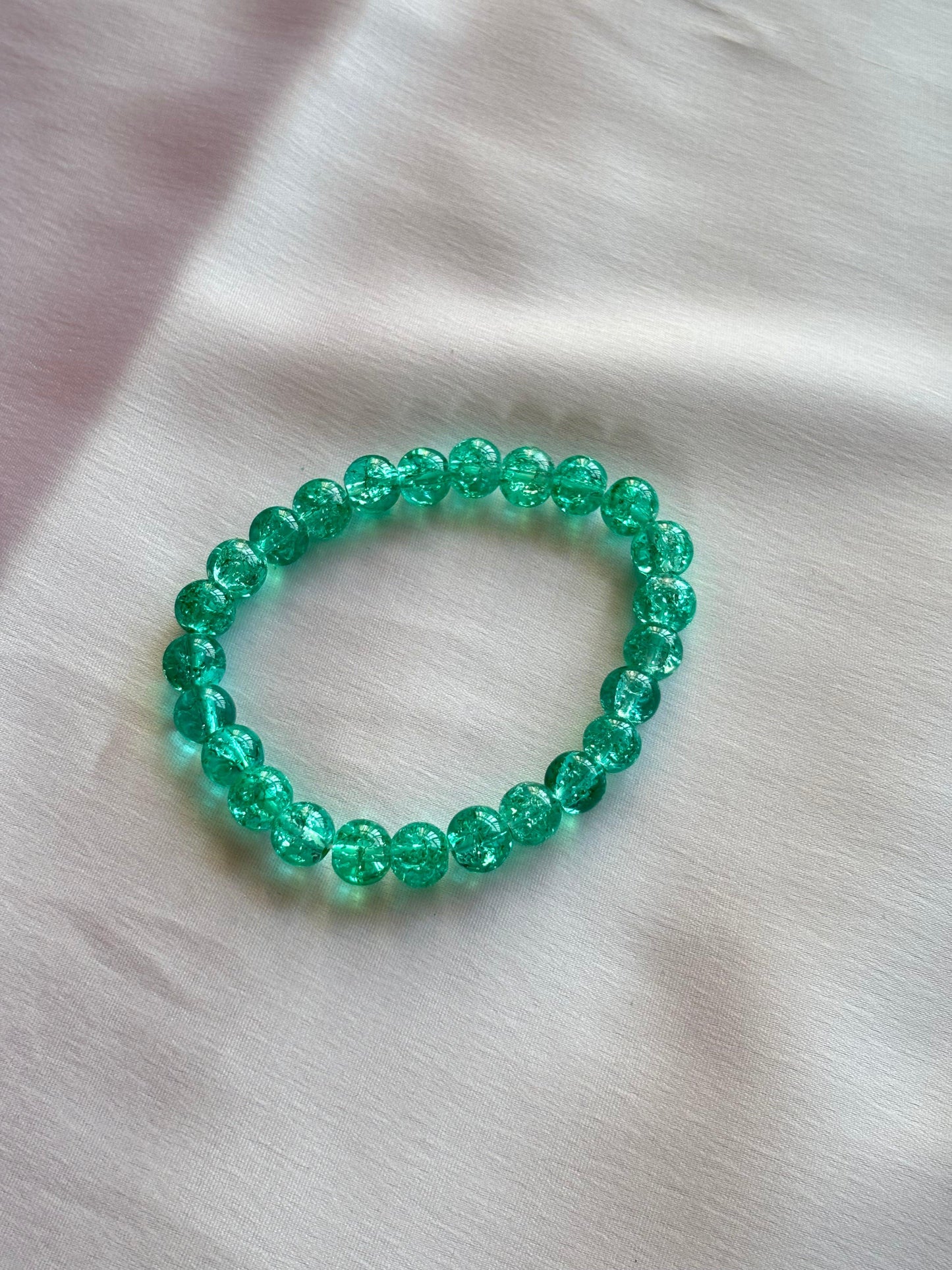 Festive holiday bracelet in vibrant green hues, perfect for celebrating the seasonal spirit.