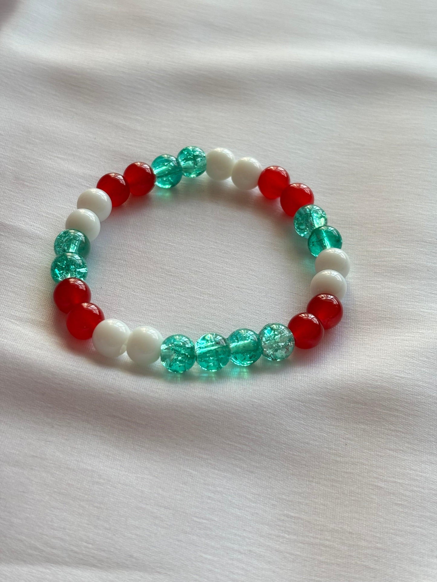 Festive holiday bracelet set featuring red, green, and white beads, perfect for celebrating the season.