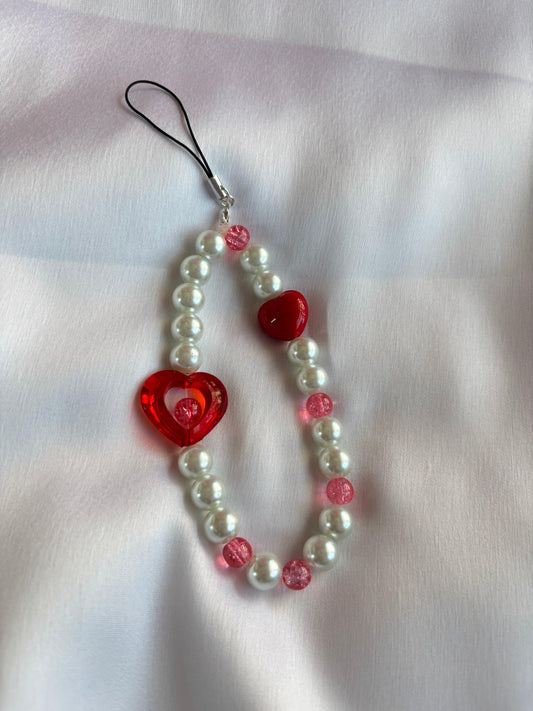 Ruby Love Mobile Charm featuring red heart and pearl beads, perfect accessory for smartphones.