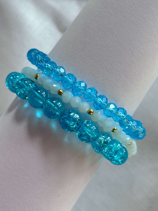 Stunning blue bracelet stack with three bracelets featuring vibrant blue and white beads, perfect for adding elegance to any outfit.